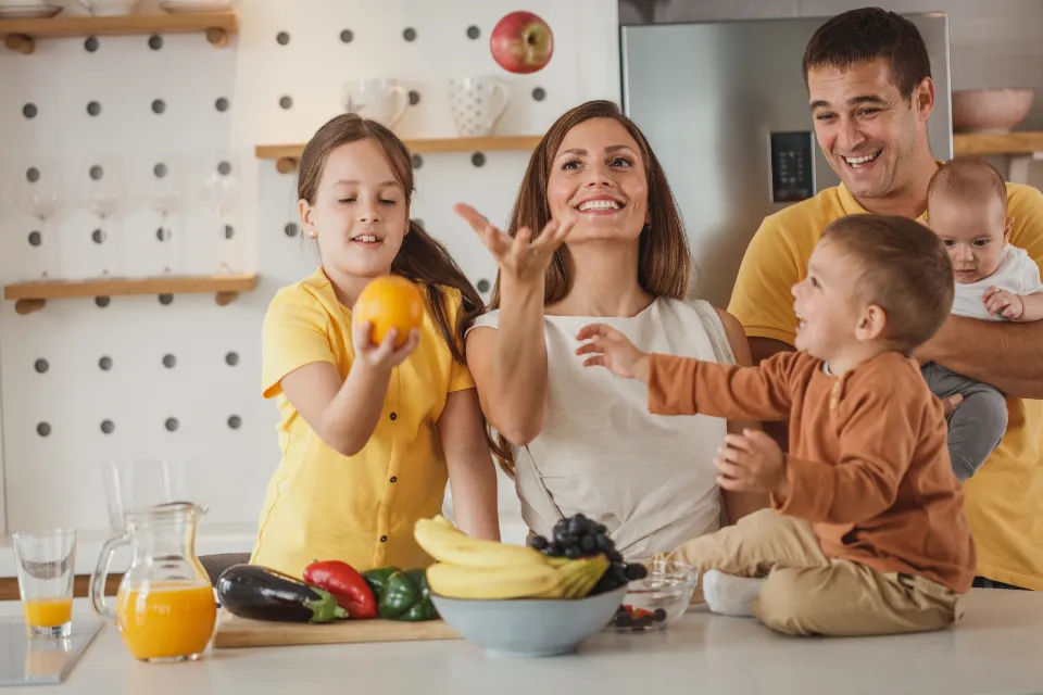 A family laughing together around a kitchen table